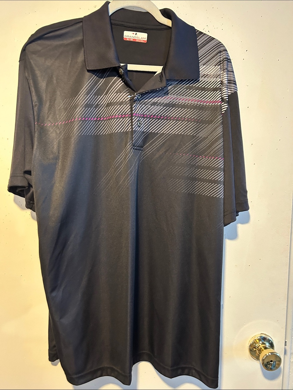 Grand Slam Black Polo with Subtle Stripe Accents